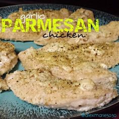 some chicken on a blue plate with the words garlic parmesan chicken