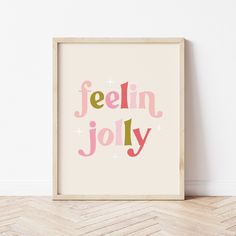 a framed poster with the words feelin'jolly in pink and green on it