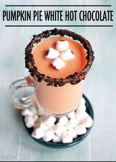 a drink with marshmallows in it on a plate