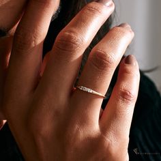 a close up of a person's hand with a ring on it