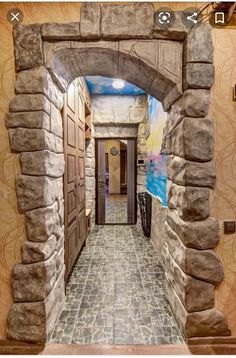 an open door leading into a hallway with stone walls and doors on either side of the doorway