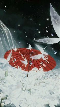 a red umbrella sitting on top of snow covered ground next to flowers and falling leaves