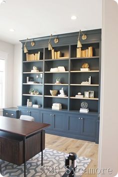 an office with built in bookshelves and desk