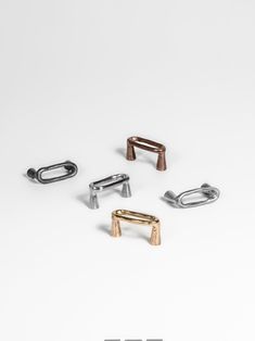 four different types of metal clips on a white surface with the word,'it is not