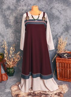 Scandinavian Apron is a typical part of clothes for Viking woman in any social status. It's made of wool or linen in a selected colour. Linen upon request. Construction of this apron is based on analysis of Scandinavian archaeologists. The apron has a classic rectangular cut with two wedges on the sides. Attached to brooches, the strap is one piece of fabric and is not cut in half (can be made upon request). Decorated with hems in a contrasting color, top hem is decorated with an additional 100% Fall Dresses With Historical Design, Viking Tunic Dress, Viking Dress Woman Medieval Collectibles, Viking Apron Dress Embroidery, Linen Viking Dress, Viking Dress Woman Amazon.com, Viking Apron Dress, Invisible Stitch, Historical Reenactment