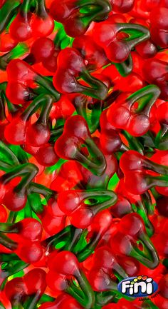 red peppers with green stems and leaves in the foreground, as if they were floating or floating on water