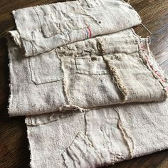 three pieces of cloth sitting on top of a wooden floor