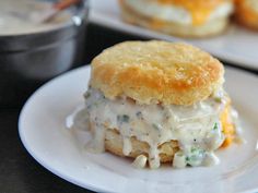 two plates with biscuits covered in cheese and sauce