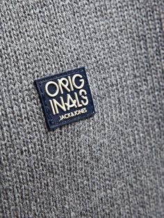 an origi inals logo is shown on the back of a gray sweater