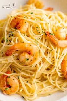 pasta with shrimp and parsley in a white bowl