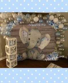 an elephant themed birthday party with blue and silver balloons on the wall, white polka dots