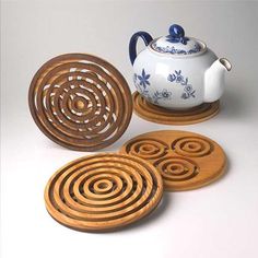 three coasters and a teapot on a table