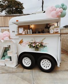 a food truck decorated with balloons and flowers