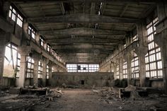 an abandoned building with lots of windows and debris