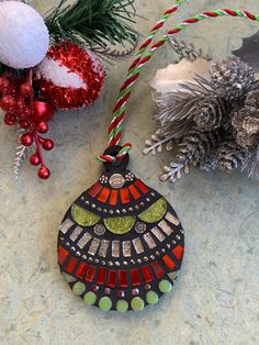 a christmas ornament sitting on top of a table next to other ornaments and decorations