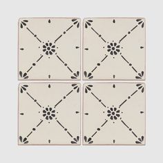 four square tiles with black and white designs