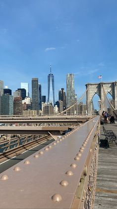 the city skyline is seen from across the bridge