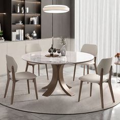 a dining room table with white chairs around it