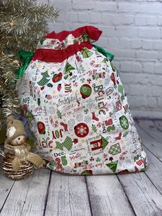 a christmas bag sitting next to a small tree