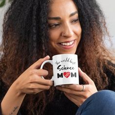 a woman is holding a coffee mug with her dog's name written on it