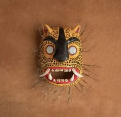 an animal mask is hanging on the wall