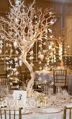 the centerpieces are made out of branches and lit up with candles in them