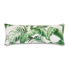 a green and white tropical print pillow on a white background