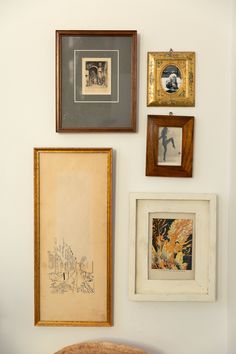 there are many framed pictures on the wall