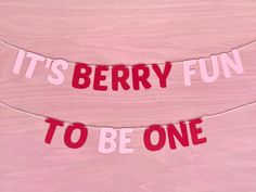 it's berry fun to be one banner hanging on a string in front of a pink wall