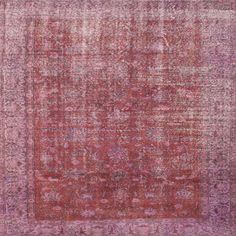 an antique rug with pink and red colors