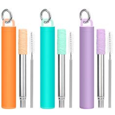 three different colored toothbrushes and one with a metal holder in the middle, on a white background