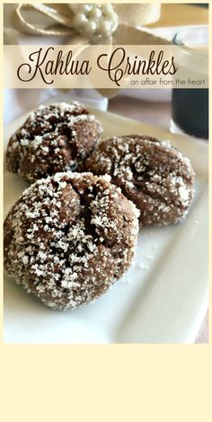 chocolate covered cookies on a white plate with powdered sugar sprinkled on top