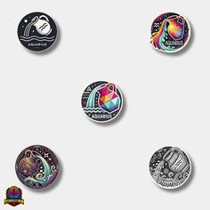 six different colored buttons on a white surface with the words aquarius and an image of a fish