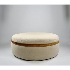 a round ottoman with wooden trim on it