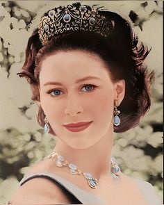 a woman wearing a tiara and blue eyes