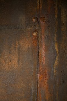 an old rusted metal surface with rivets