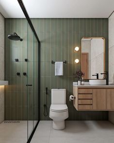 a bathroom with a toilet, sink and shower stall is shown in this image from the front view