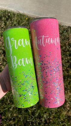 two pink and green glittered tumbles with the words grandma, natural born on them