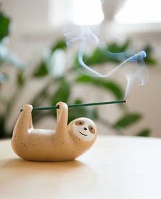 a slotty incense burner sitting on top of a table