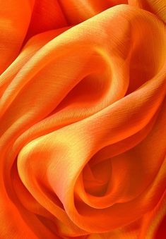 an orange silk fabric is shown in close up