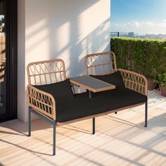 two wicker couches sitting on top of a wooden floor next to a balcony