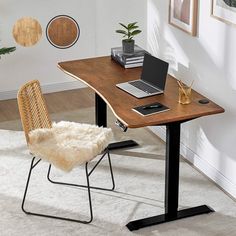 a computer desk with a laptop on it and a chair in front of the desk