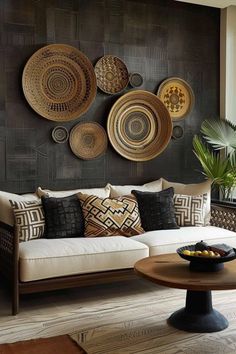 a living room filled with furniture and lots of plates hanging on the wall above it