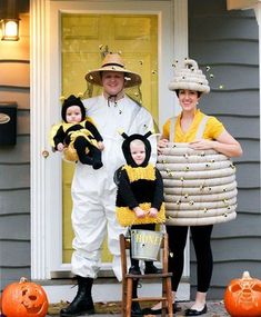 two adults and one child dressed up in costumes