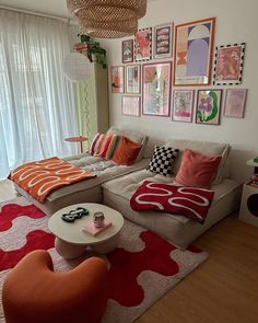 a living room filled with lots of furniture and pictures on the wall above it's couches