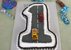 a cake shaped like a road with cars on it