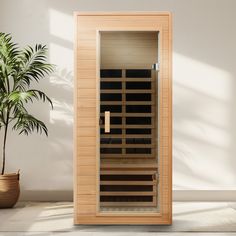 an indoor sauna is shown in front of a potted plant