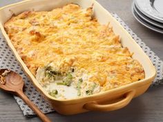 a casserole dish with broccoli and cheese in it on a table