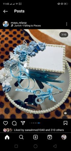 a cake decorated with blue flowers and pearls on a plate that is sitting on a leopard print tablecloth