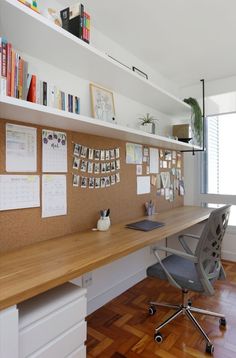 an office with a desk, chair and bookshelf filled with papers on it